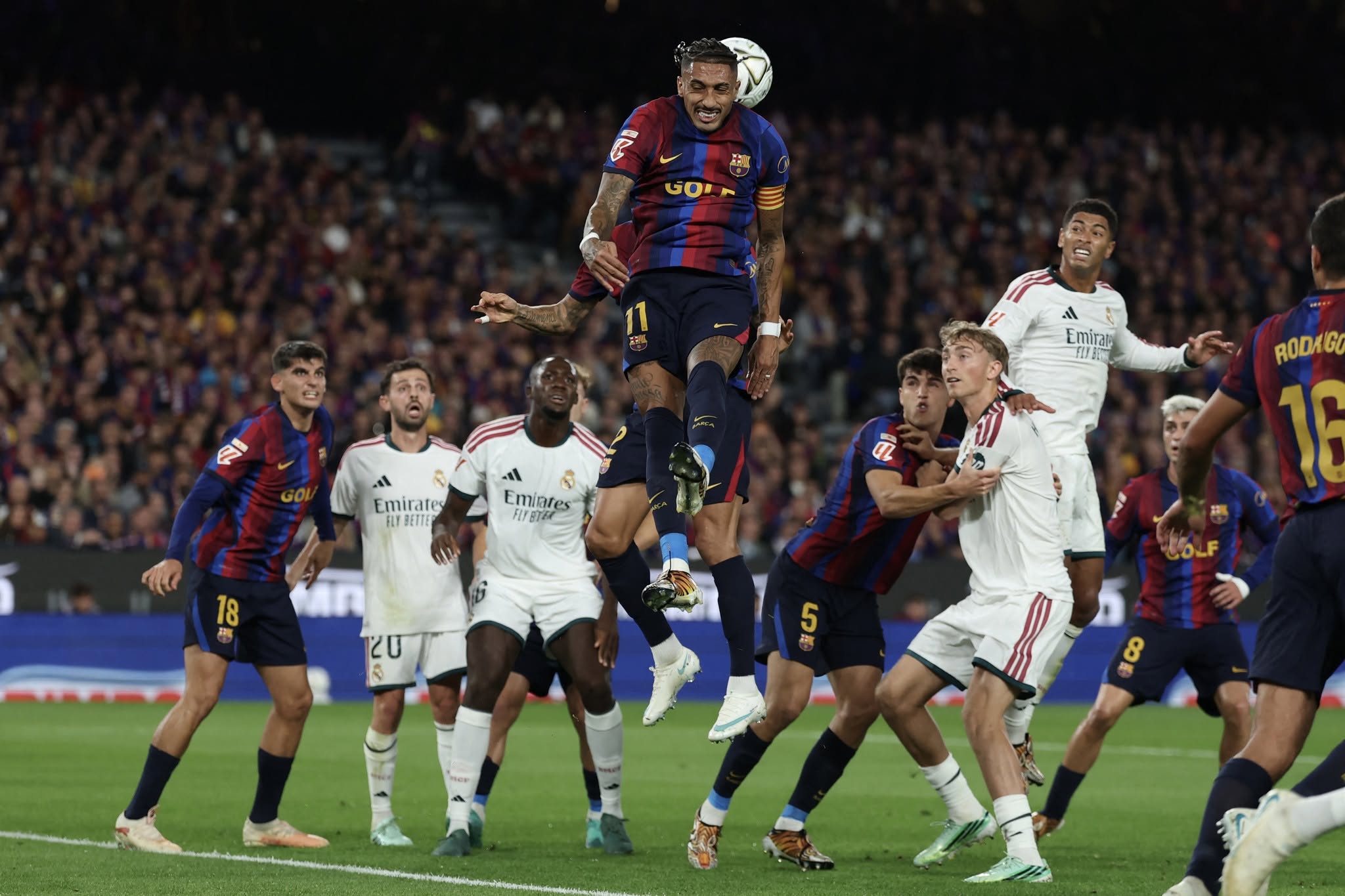 Barcelona's Brazilian forward #11 Raphinha (C) heads the ball during the Spanish league football match between FC Barcelona and Real Madrid CF at Camp Nou Stadium in Barcelona on October 25, 2026. (Photo by Lluis GENE / AFP)