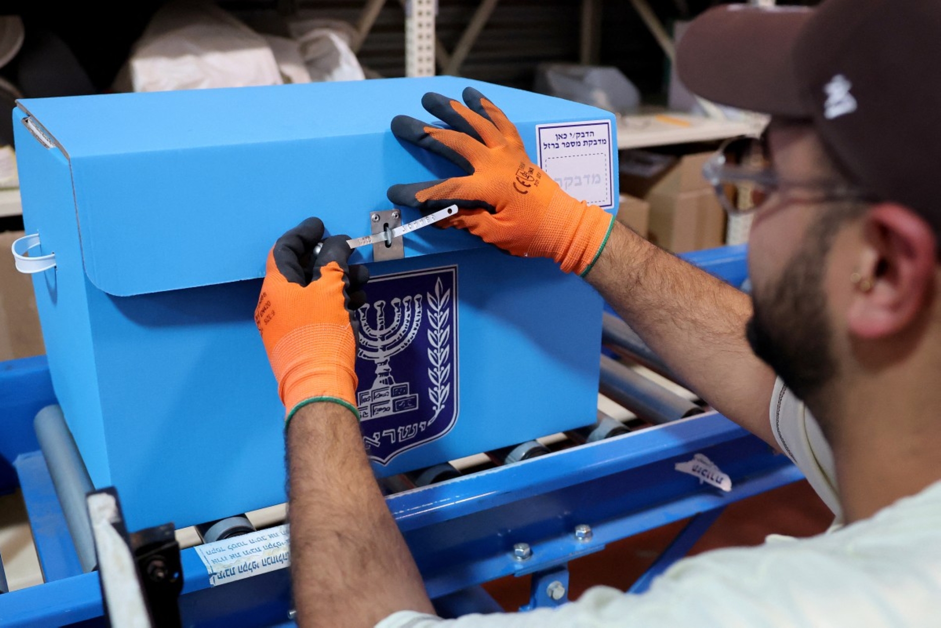 A worker seals A ballot box at the headquarters of the Israeli Central Elections Committee near the central town of Shoham on October 14, 2026, ahead of Israel's legislative election. Israel heads to the polls on October 27 in its first election since the October 7, 2023 Hamas-led attack, in what is seen as a referendum on the prime minister. (Photo by JACK GUEZ / AFP)