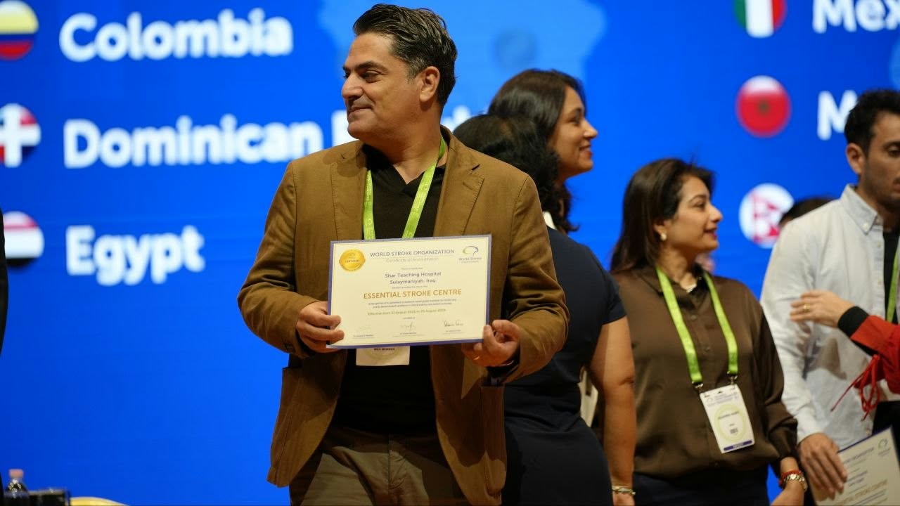 Dr. Zana Abdulrahman (center) holding the official World Stroke Organization "Essential Stroke Centre" certification awarded to Shar Hospital at the global congress in South Korea.