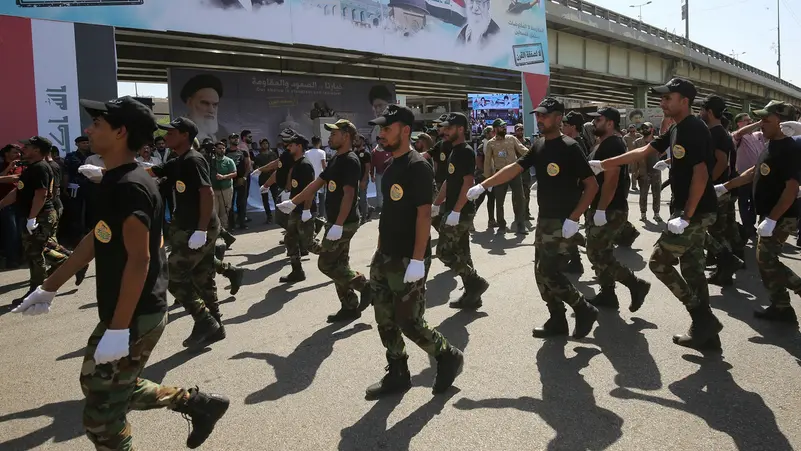 Harakat al-Nujaba members march during a military parade in Baghdad. Photo: AFP