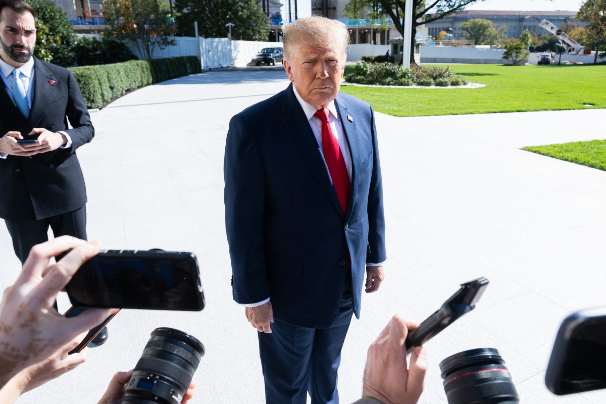 US President Donald Trump speaks to the media as he walks to Marine One prior to departure from the South Lawn of the White House in Washington, DC, October 25, 2026. President Trump is travelling to Michigan to speak at a midterm election rally. (Photo by SAUL LOEB / AFP)