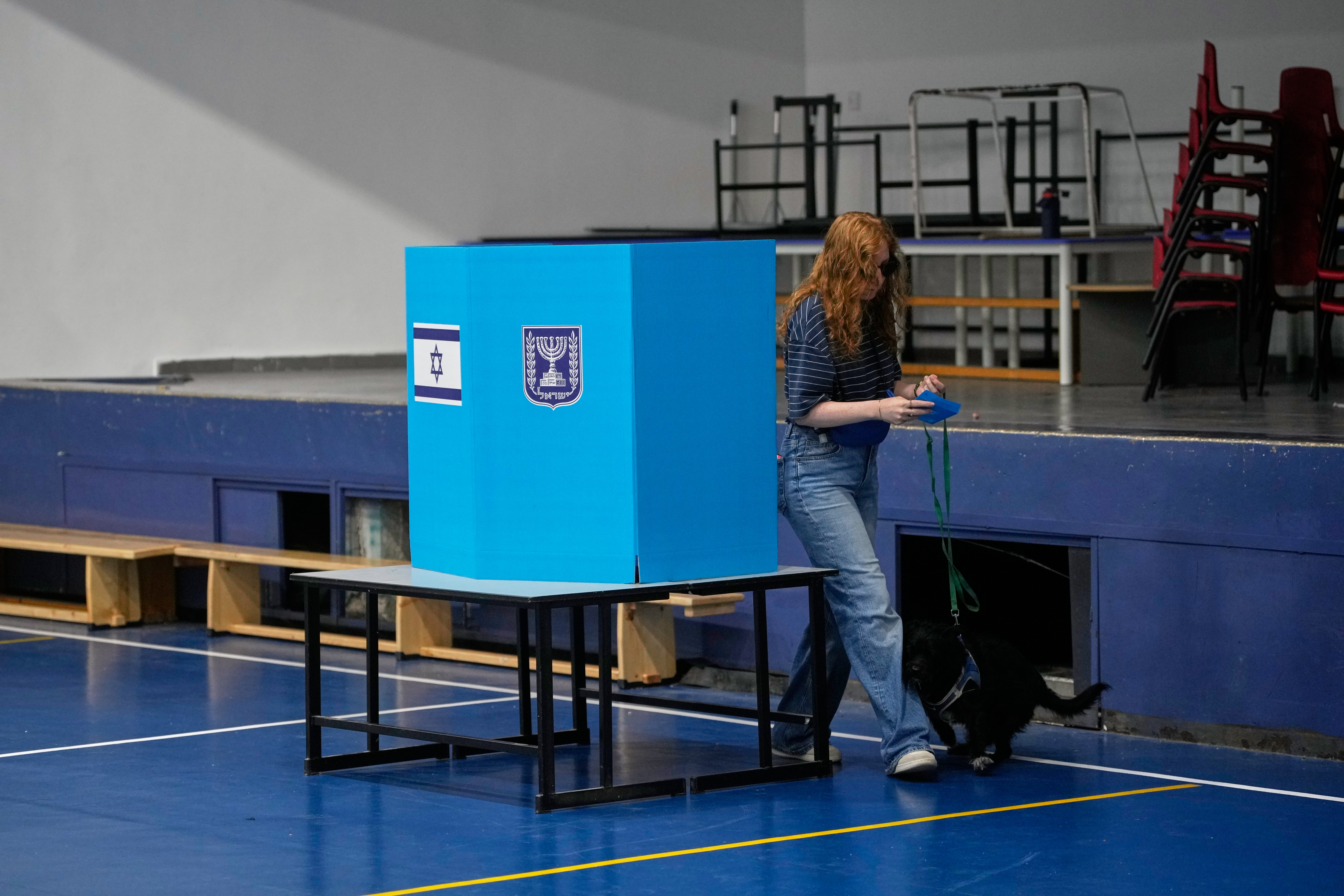 A woman casts her ballot at a polling station during Israel's general election in Jerusalem, Tuesday, Oct. 27, 2026. (AP Photo/Ohad Zwigenberg)
