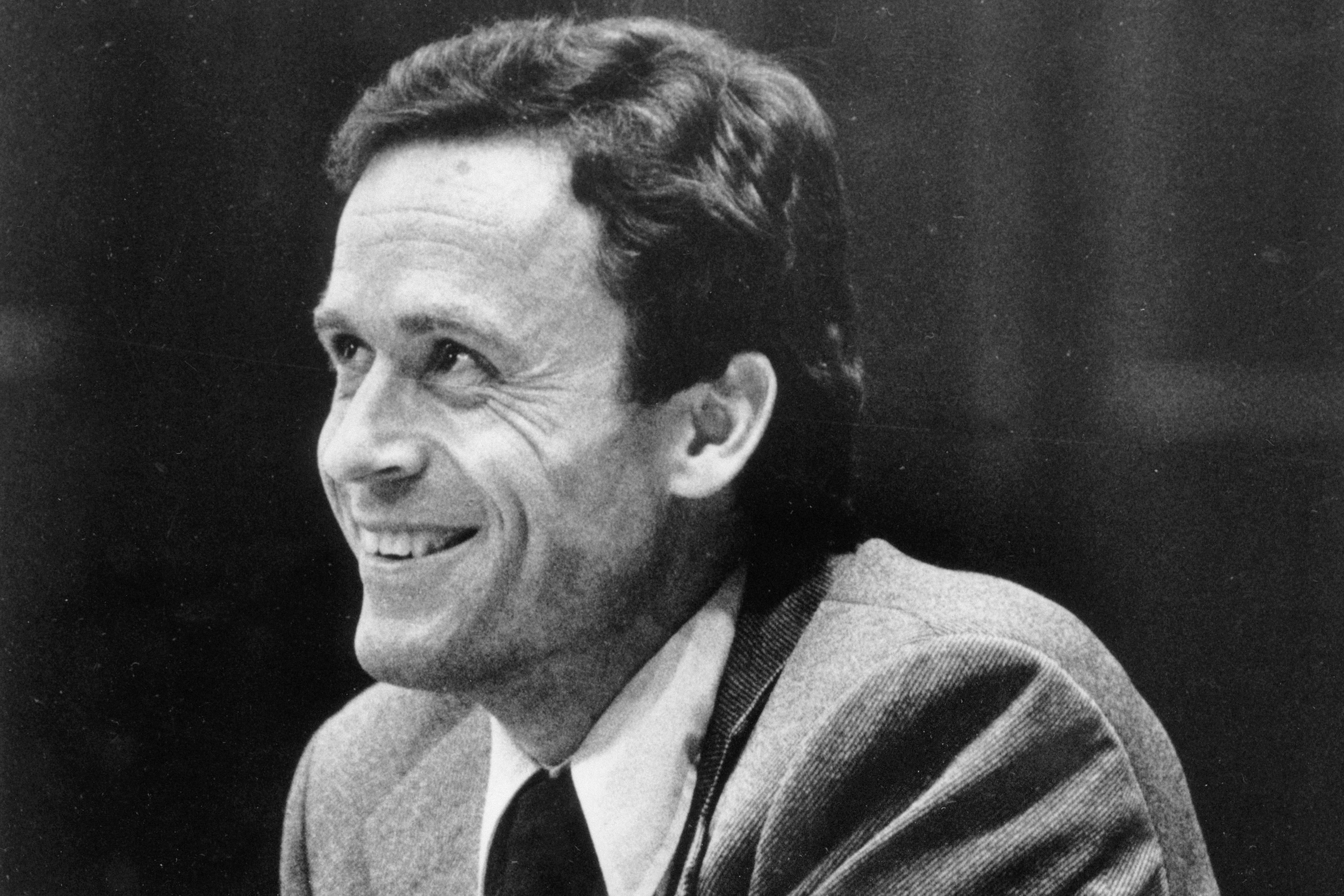 FILE - Ted Bundy smiles during the second day of jury selection for his murder trial in a Dade County courtroom in Miami, June 27, 1979. (AP Photo, Pool, File)