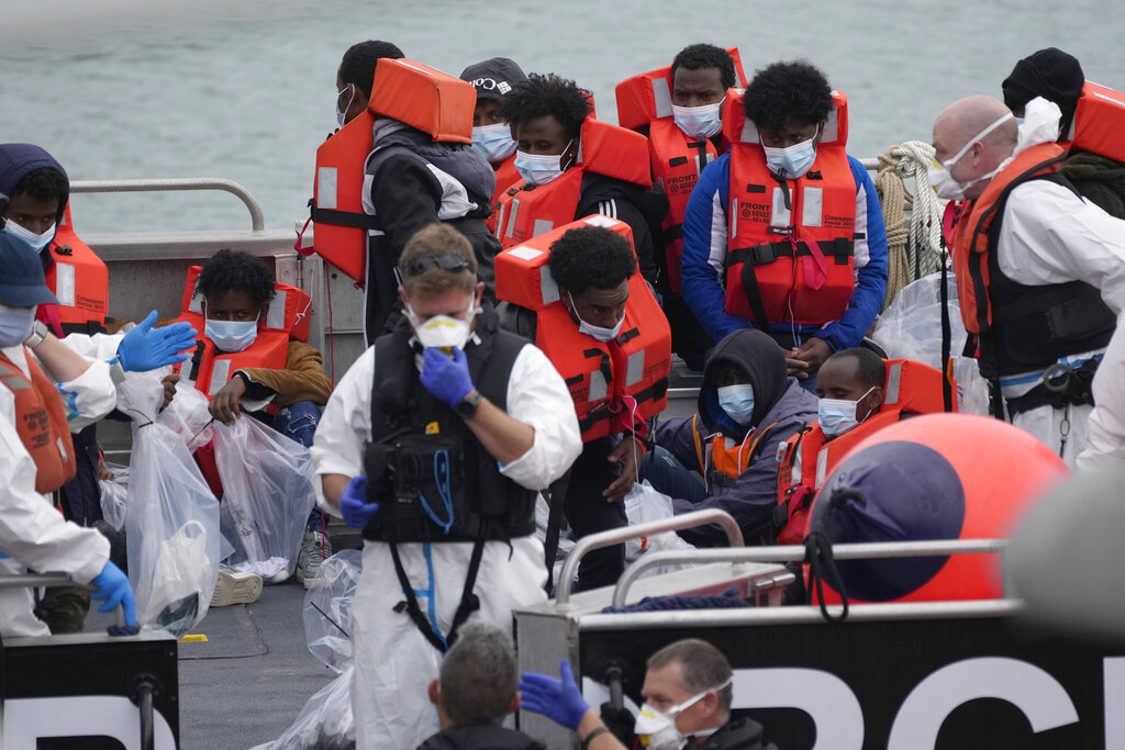 People thought to be migrants who made the crossing from France are disembarked after being picked up in the Channel by a British border force vessel in Dover, south east England, Friday, Aug. 13, 2021. (AP Photo/Matt Dunham)