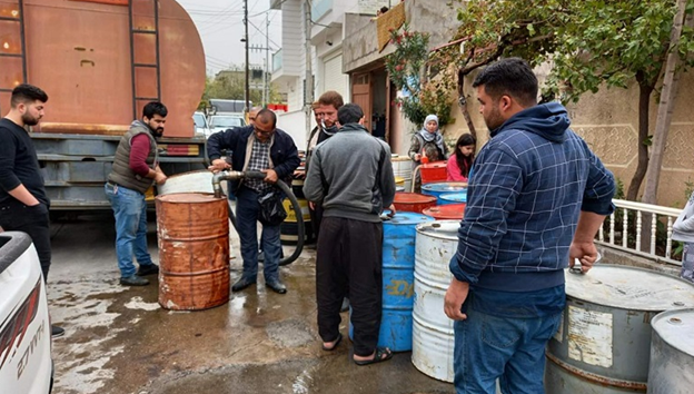 Residents line up for Kerosene. 