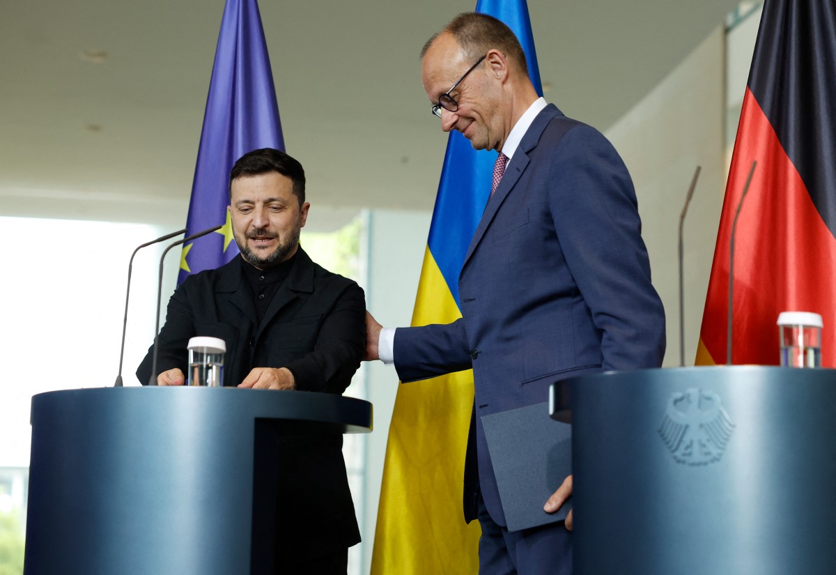 German Chancellor Friedrich Merz (R) and Ukrainian President Volodymyr Zelensky leave after giving a joint press conference at the Chancellery in Berlin on May 28, 2025. (Photo by Odd ANDERSEN / AFP)