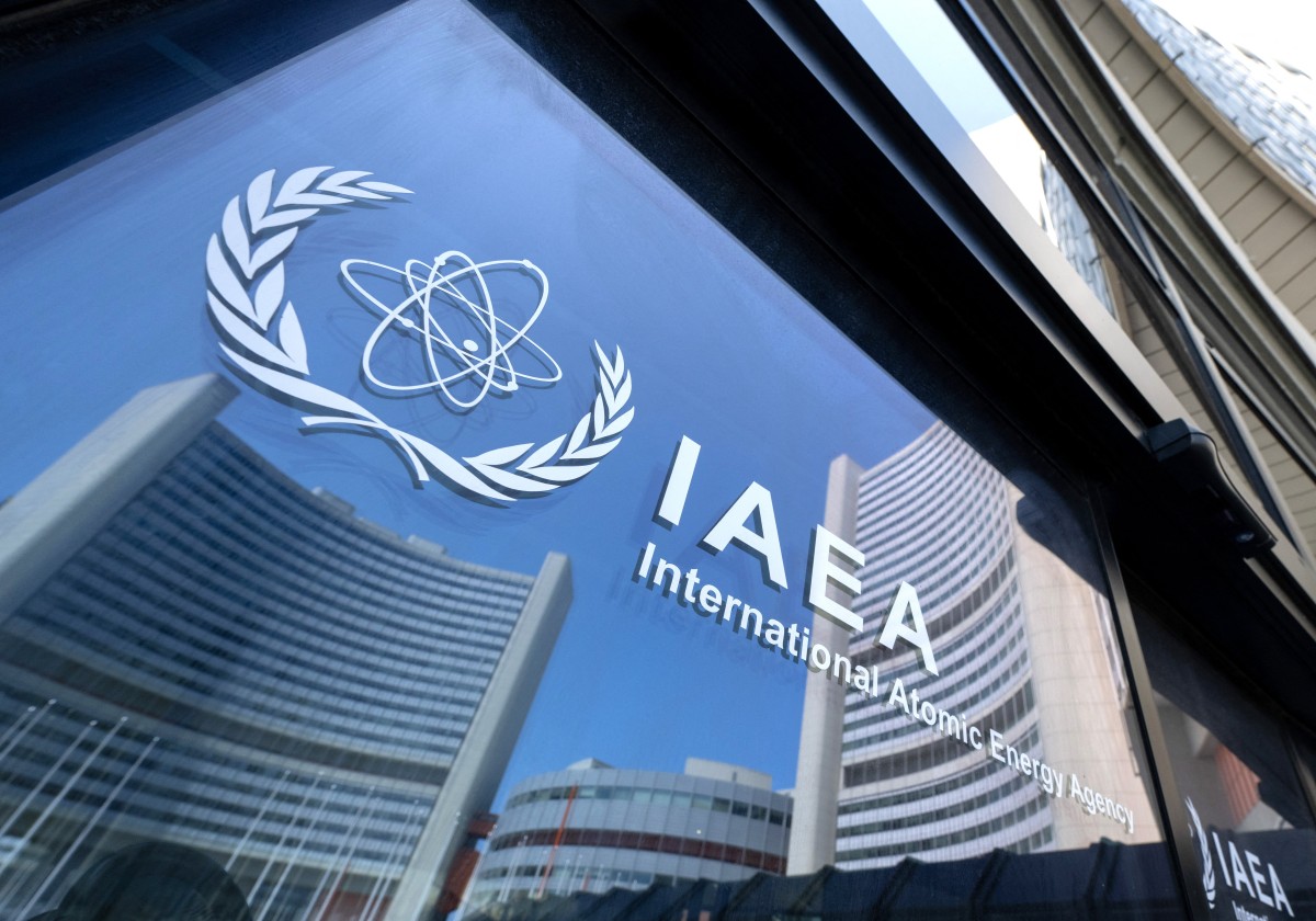 Buildings of the International Atomic Energy Agency (IAEA) headquarters reflect in doors with the agency's logo during the IAEA’s Board of Governors meeting in Vienna, Austria on June 13, 2025.