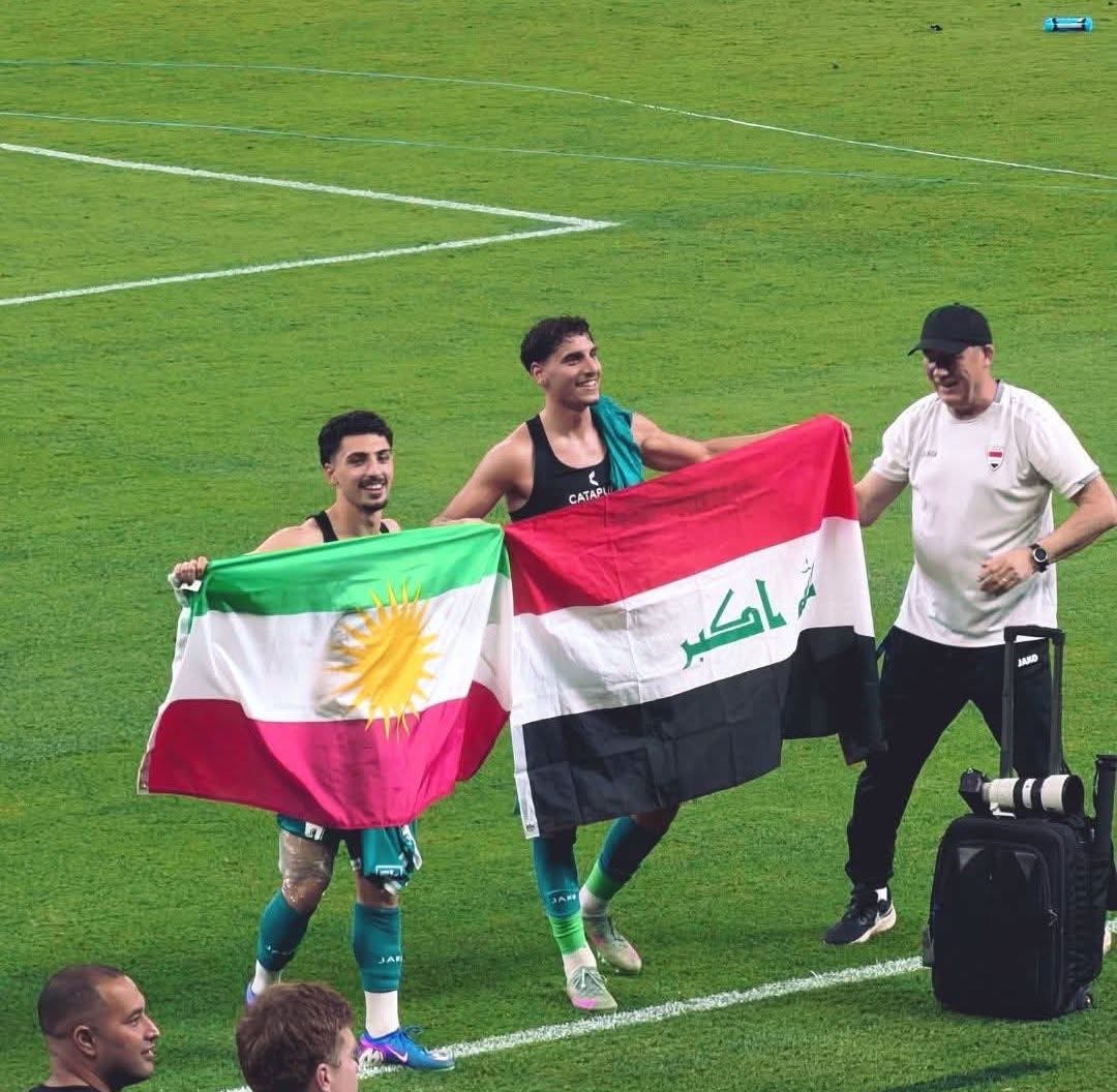 Two members of the Iraqi national team celebrated their World Cup qualification by raising both the Kurdistan and Iraqi flags                     