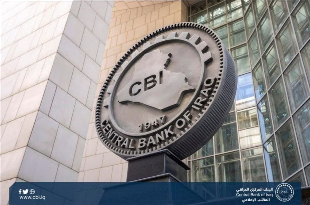 This image shows the large, circular metallic emblem of the Central Bank of Iraq mounted outside its modern headquarters building. Photo: CBI  