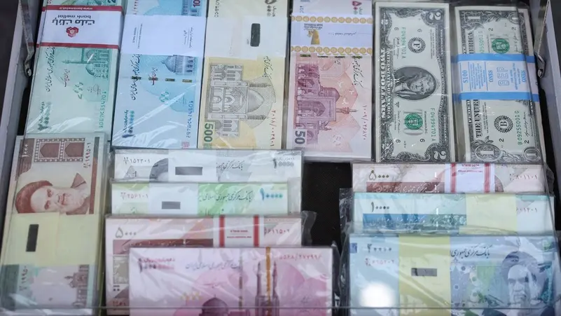 Iranian rial bills are displayed at a currency exchange in Tehran, Iran,