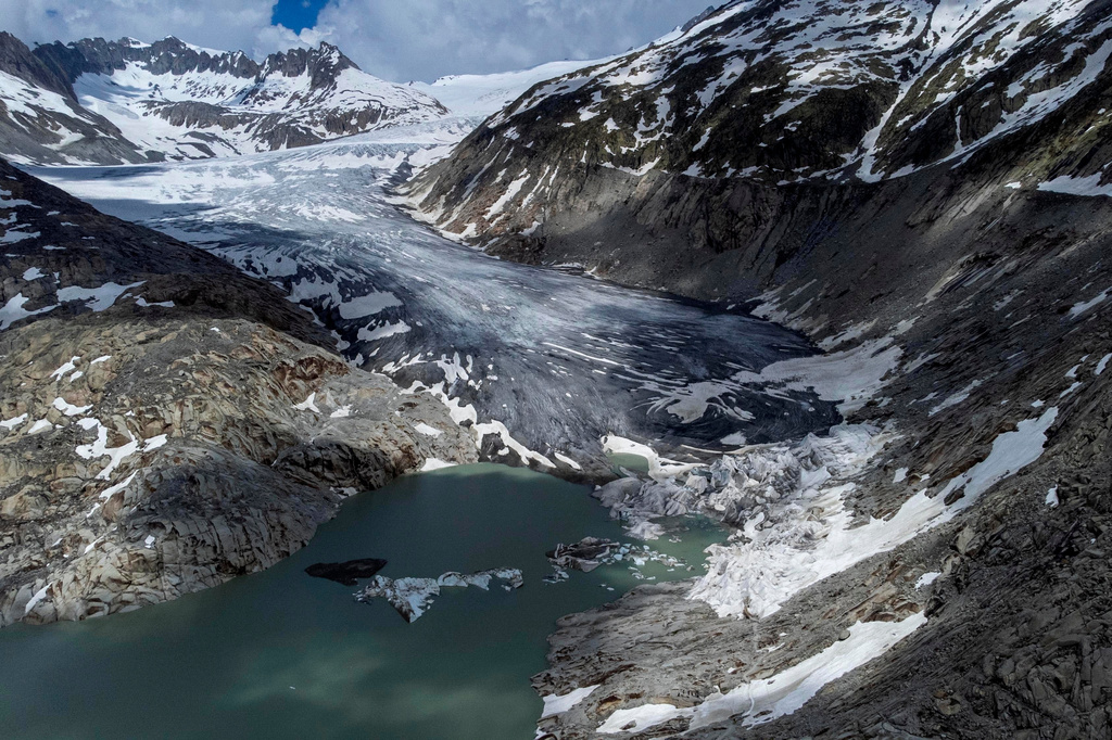 FILE — A lake of meltwater has formed on the tongue of the Rhone glacier near Goms, Switzerland, June 13, 2023. (AP Photo/Matthias Schrader, File)