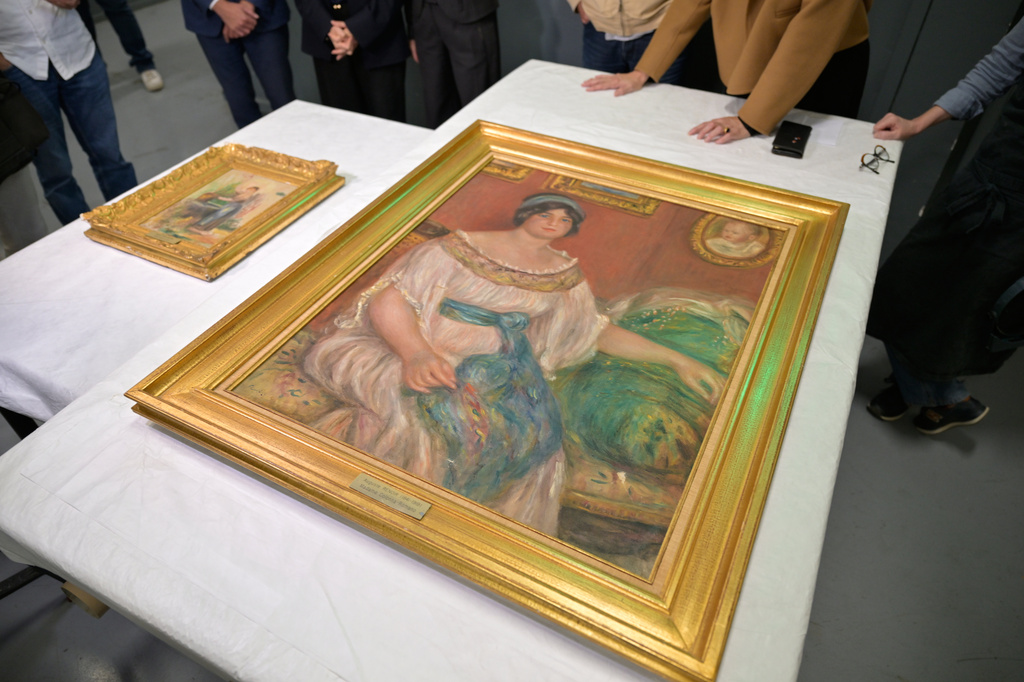 Recovered paintings "Portrait of Madame Colonna Romano", right, and "Young Woman at the Well," stolen from the Renoir Museum in Cagnes-sur-Mer are on display at the Interdisciplinary Centre for the Conservation and Restoration of Heritage in Marseille, France, Monday Oct. 12, 2026. (AP Photo/Philippe Magoni)